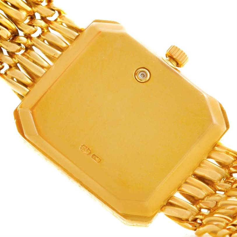 The image shows the back case and part of the bracelet of the Patek Philippe 4667 Women's Yellow Gold Beige Dial 4667 Women's Yellow Gold Beige Dial 18k Yellow Gold Diamond Emerald Ladies Watch, model 4667.