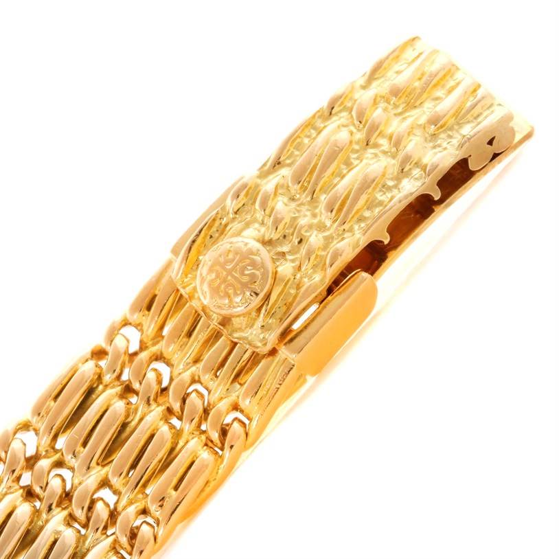 The image shows the clasp and part of the bracelet of a Patek Philippe 4667 Women's Yellow Gold Beige Dial 4667 Women's Yellow Gold Beige Dial 4667 18k Yellow Gold Diamond Emerald Ladies Watch.