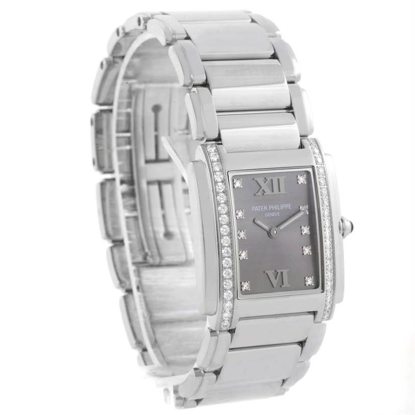 The image shows a left-side angle of the Patek Philippe Twenty-4 4910/10A-010 Women's Stainless Steel Grey Dial 4910/10A-010 Women's Stainless Steel Grey Dial watch, highlighting its bracelet, face, and diamond accents.