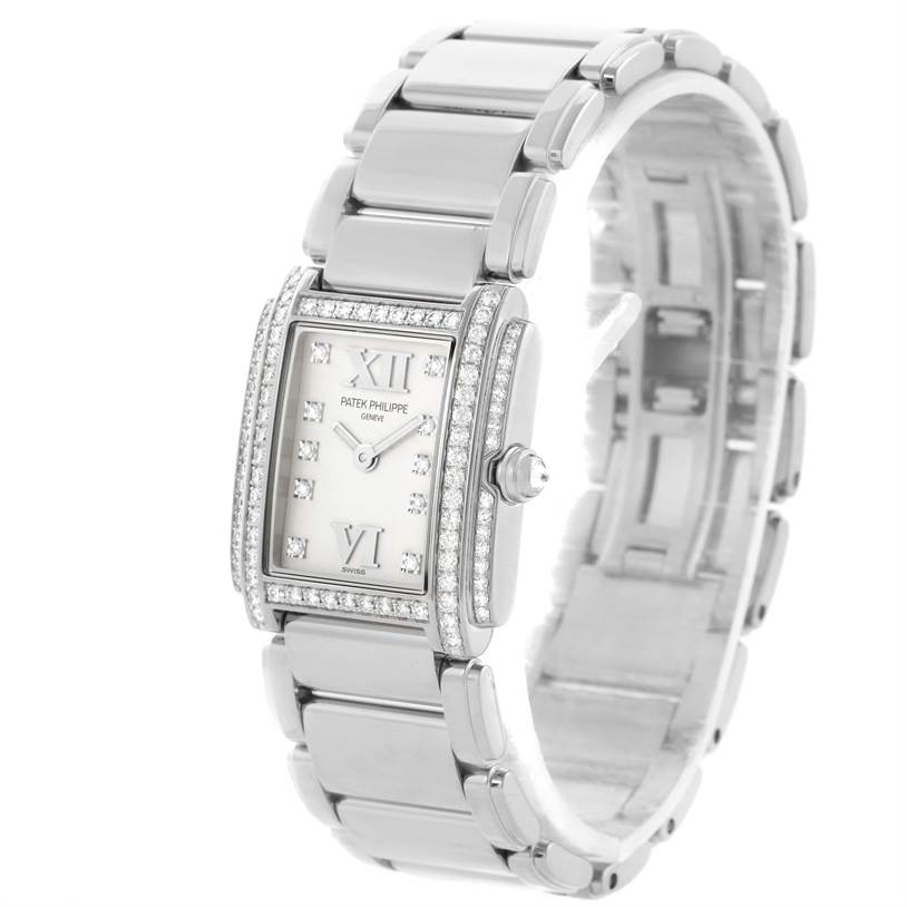 The Patek Philippe Twenty-4 4908/200G-011 Women's White Gold Silver Dial 4908/200G-011 Women's White Gold Silver Dial watch is shown at a three-quarter angle, displaying its face, bracelet, and side crown.