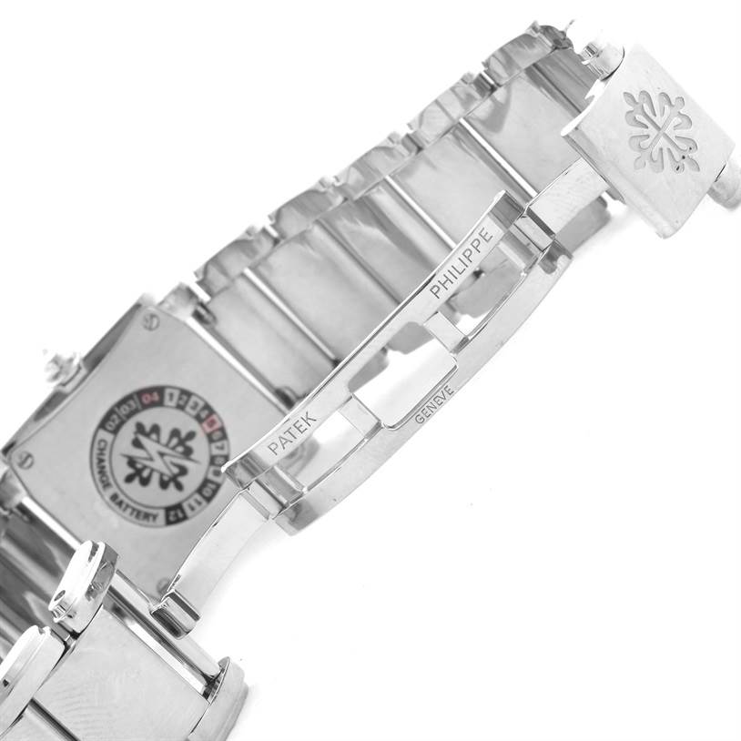 The image shows the underside of the bracelet and clasp of the Patek Philippe Twenty-4 4908/200G-011 Women's White Gold Silver Dial 4908/200G-011 Women's White Gold Silver Dial watch, highlighting the engraved brand details.