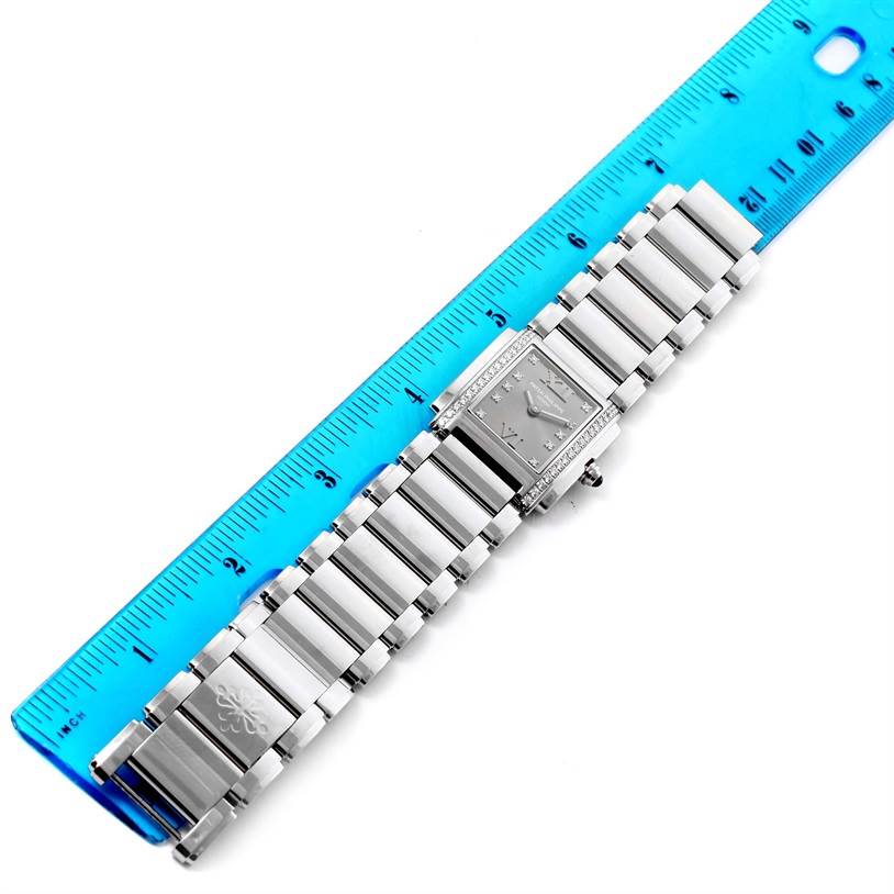 The Patek Philippe Twenty-4 4910/10A-010 Women's Stainless Steel Grey Dial 4910/10A-010 Women's Stainless Steel Grey Dial watch is shown from a top-down angle next to a ruler, displaying the full bracelet and face.