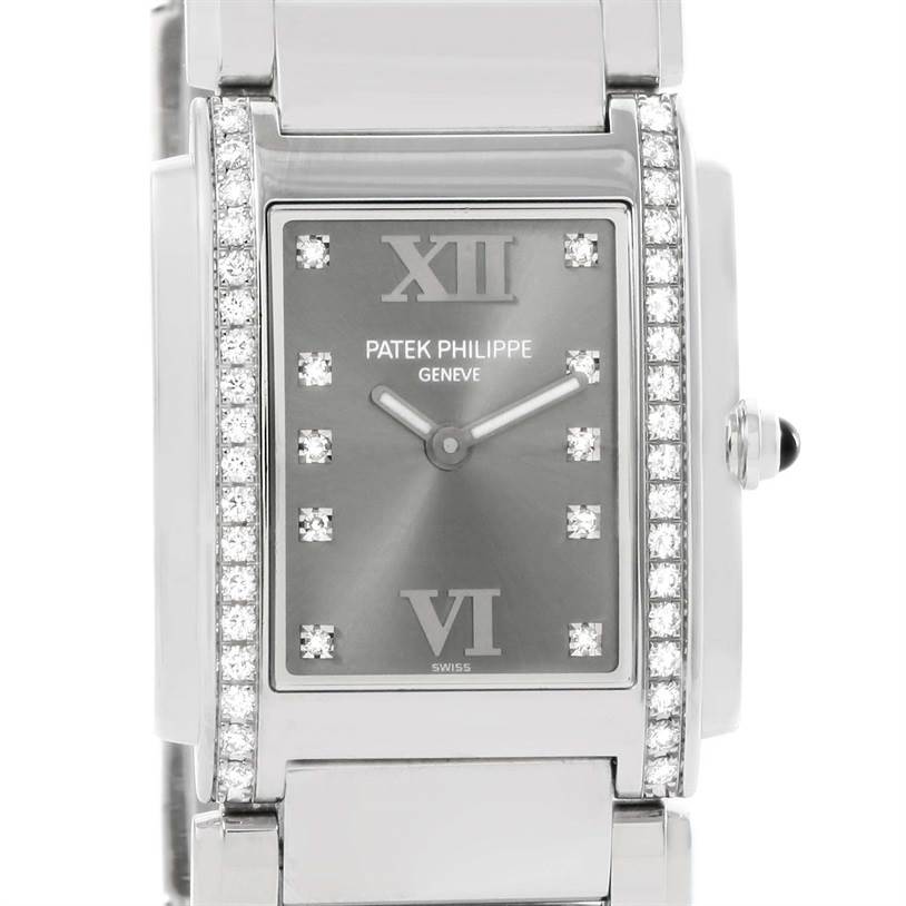 The image shows a front view of the Patek Philippe Twenty-4 4910/10A-010 Women's Stainless Steel Grey Dial 4910/10A-010 Women's Stainless Steel Grey Dial watch, highlighting its diamond-studded bezel, dial, and crown.