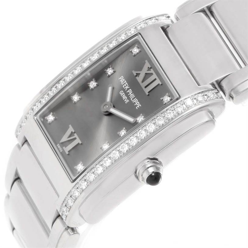 This image shows the Patek Philippe Twenty-4 4910/10A-010 Women's Stainless Steel Grey Dial 4910/10A-010 Women's Stainless Steel Grey Dial watch from a tilted angle, highlighting its diamond-set bezel, dial, and crown.