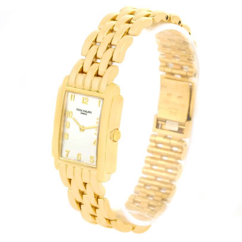 The image shows a Patek Philippe Gondolo 4824 Women's Yellow Gold White Dial 4824 Women's Yellow Gold White Dial watch at an angle highlighting the watch face, crown, and intricate gold bracelet.