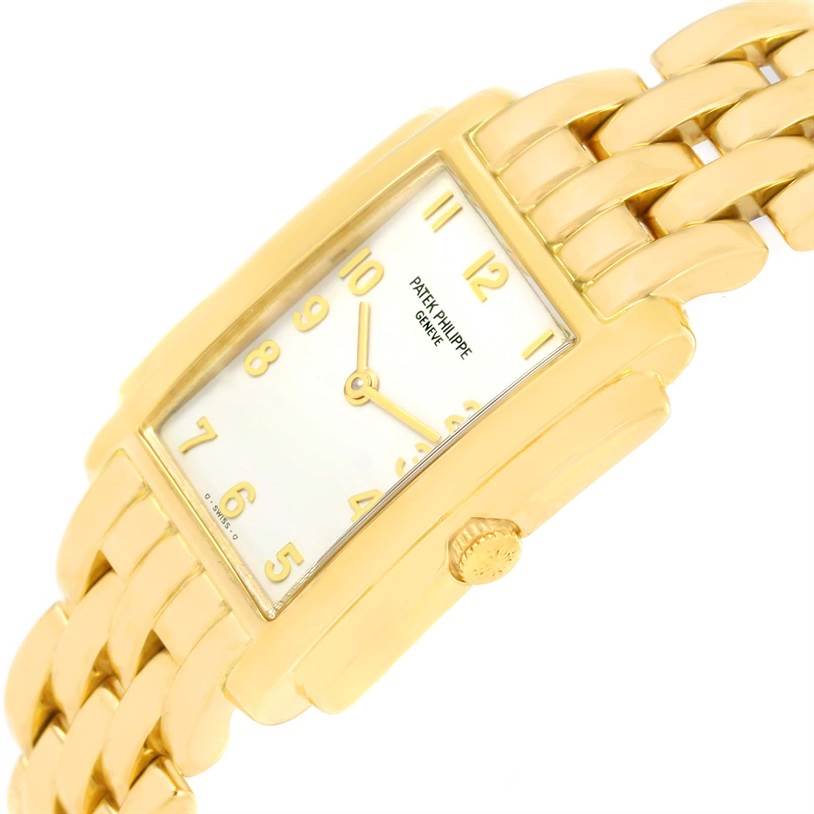 The image shows a side angle of the Patek Philippe Gondolo 4824 Women's Yellow Gold White Dial 4824 Women's Yellow Gold White Dial watch, highlighting the rectangular dial, gold bracelet, and crown.