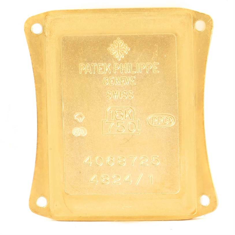 This is the backside of a Patek Philippe Gondolo 4824 Women's Yellow Gold White Dial 4824 Women's Yellow Gold White Dial watch case, displaying hallmark, serial, and model numbers.