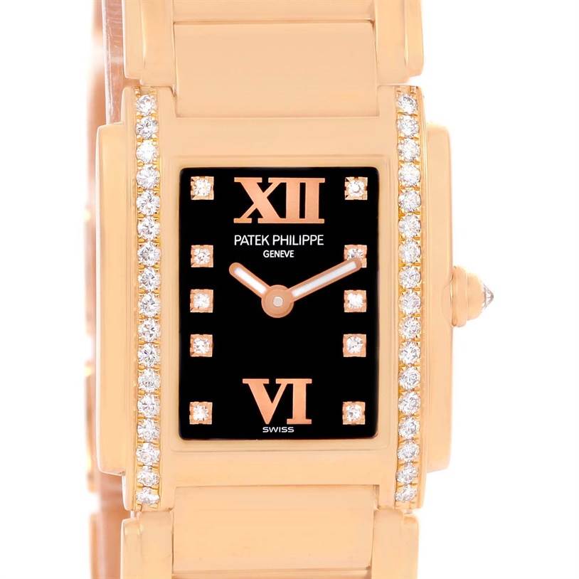 This image shows a close-up view of the Patek Philippe Twenty-4 4908/11R Women's Rose Gold Black Dial 4908/11R Women's Rose Gold Black Dial watch's black dial, diamond-set bezel, and gold bracelet links.