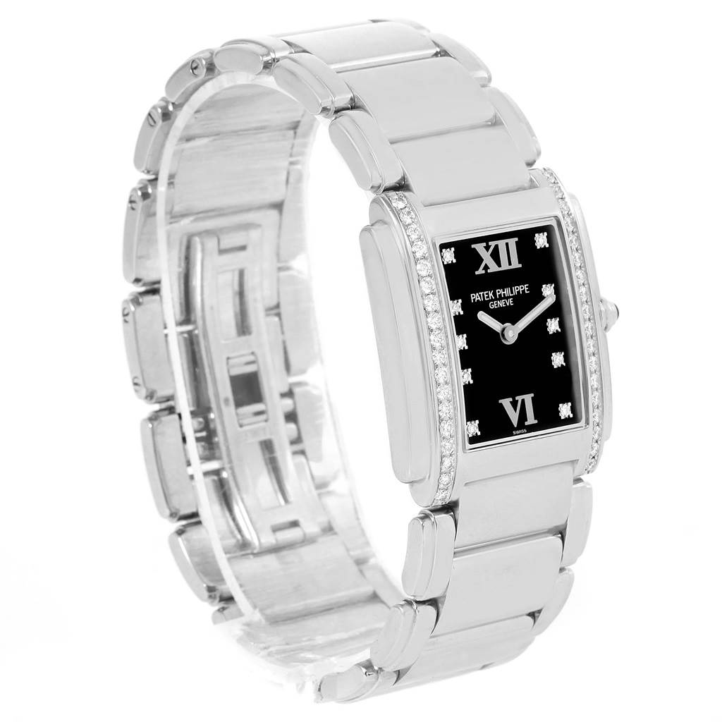 This image shows a Patek Philippe Twenty-4 4910/10A-001 Women's Stainless Steel Black Dial 4910/10A-001 Women's Stainless Steel Black Dial watch at a slight side angle, highlighting its face, bracelet, and diamond-studded bezel.