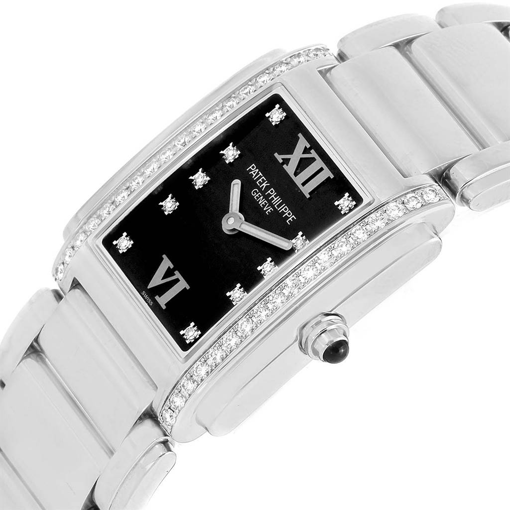 The image shows a close-up angled view of a Patek Philippe Twenty-4 4910/10A-001 Women's Stainless Steel Black Dial 4910/10A-001 Women's Stainless Steel Black Dial model, highlighting the dial, bezel, crown, and bracelet.