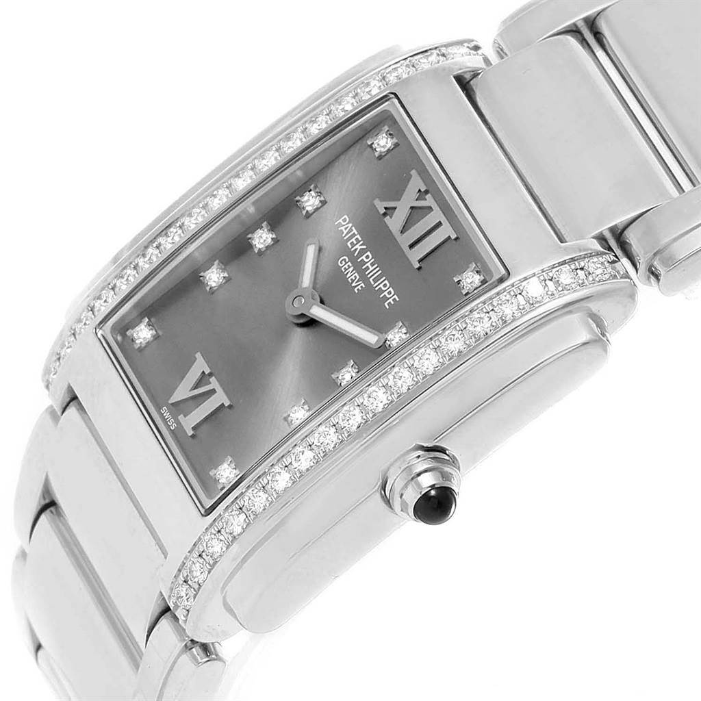The image shows a top angle of the Patek Philippe Twenty-4 4910/10A-010 Women's Stainless Steel Grey Dial 4910/10A-010 Women's Stainless Steel Grey Dial model, detailing the face, diamond markers, crown, and bracelet.