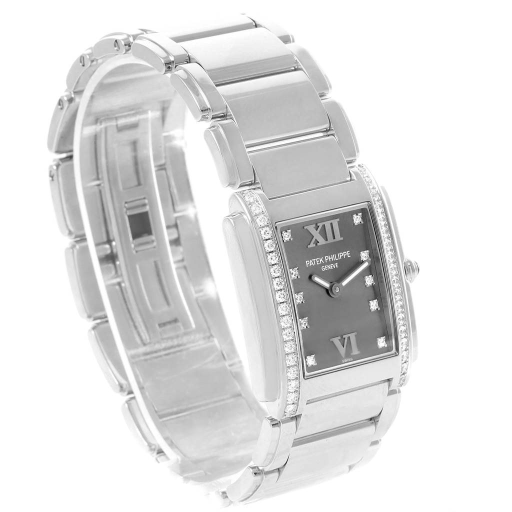 The image shows a Patek Philippe Twenty-4 4910/10A-010 Women's Stainless Steel Grey Dial 4910/10A-010 Women's Stainless Steel Grey Dial watch at a three-quarter angle, highlighting the dial, bracelet, and case.