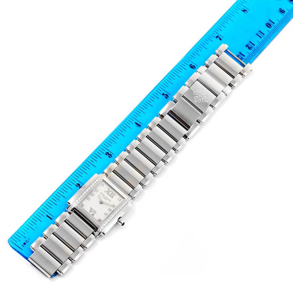 This image shows a top view of the Patek Philippe Twenty-4 4910 Women's Stainless Steel Silver Dial 4910 Women's Stainless Steel Silver Dial watch, including the face, band, and a measurement ruler for scale.
