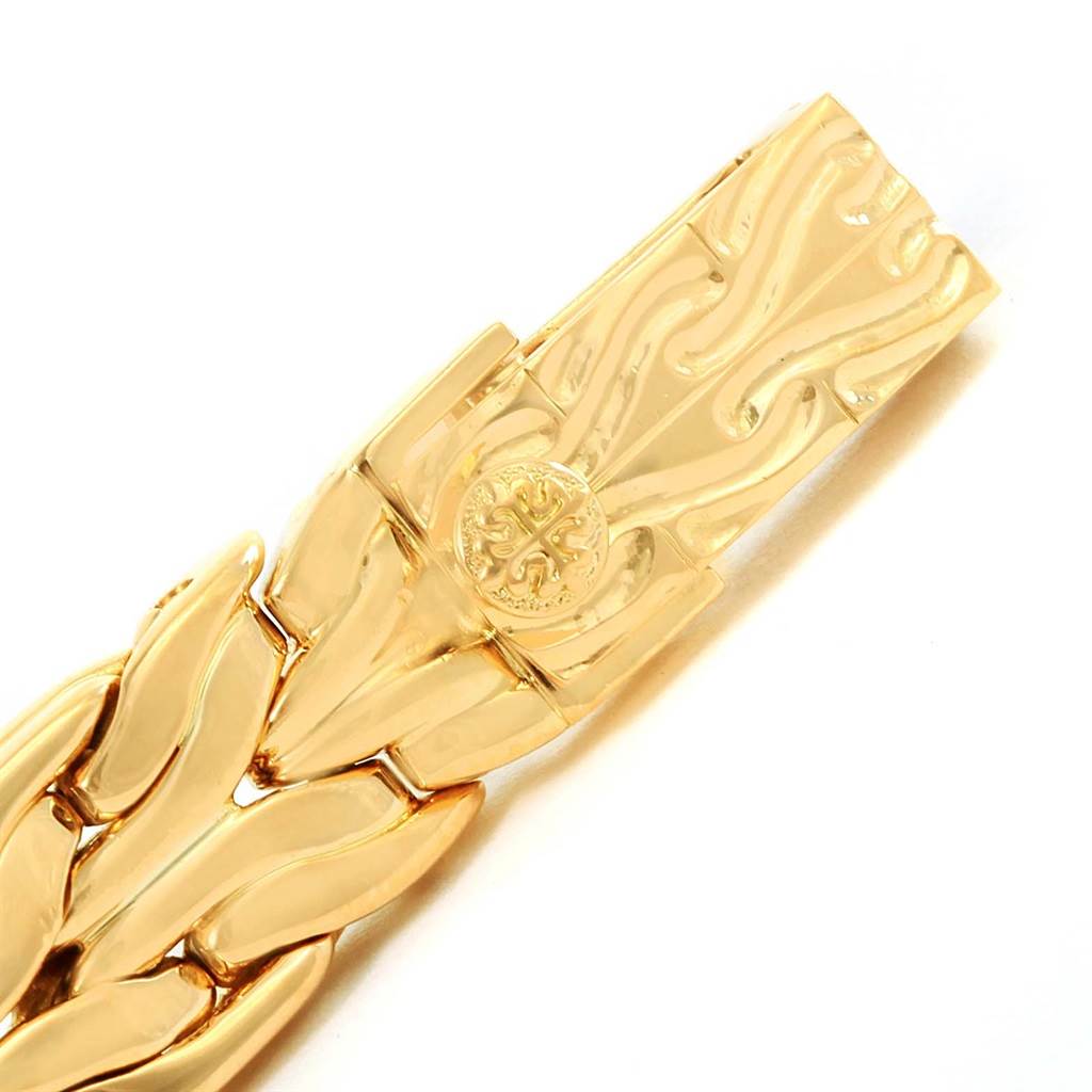 The image shows a detailed view of the gold clasp and part of the bracelet of a La Flamme model by Patek Philippe.