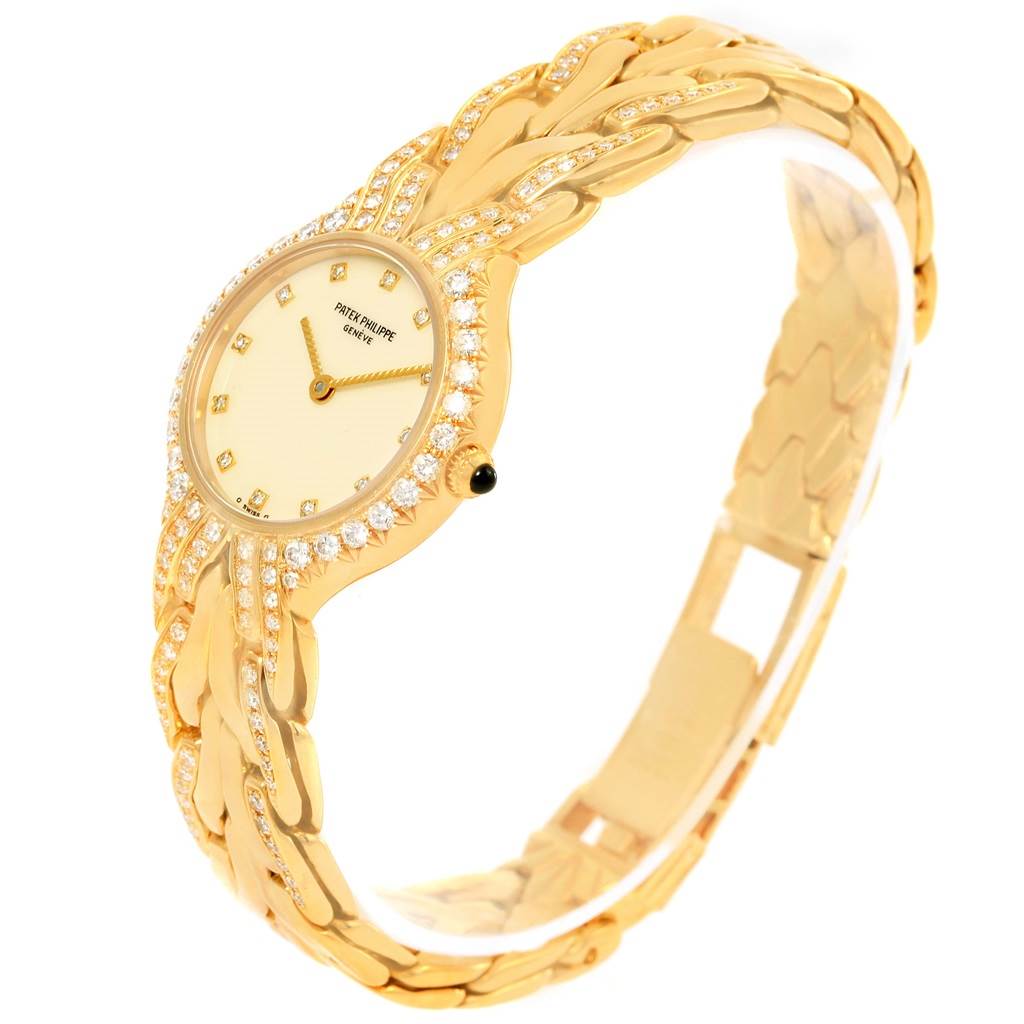The image shows the Patek Philippe La Flamme  4816 Women's Yellow Gold Beige Dial 4816 Women's Yellow Gold Beige Dialwatch at an angled side view, highlighting the watch face, bezel, and bracelet with diamond accents.