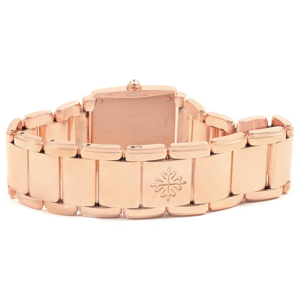 The image shows the backside and bracelet of the Patek Philippe Twenty-4 4910/11R Women's Rose Gold Brown Dial 4910/11R Women's Rose Gold Brown Dial watch, highlighting its clasp and the brand's emblem.
