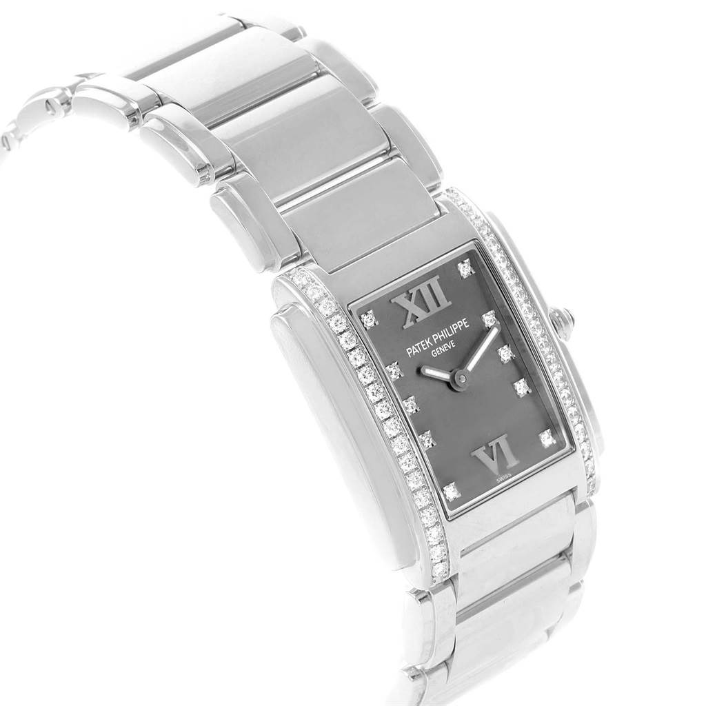 The image shows a Patek Philippe Twenty-4 4910/10A-010 Women's Stainless Steel Grey Dial 4910/10A-010 Women's Stainless Steel Grey Dial watch at a three-quarter angle, highlighting the face, bracelet, and diamond accents.