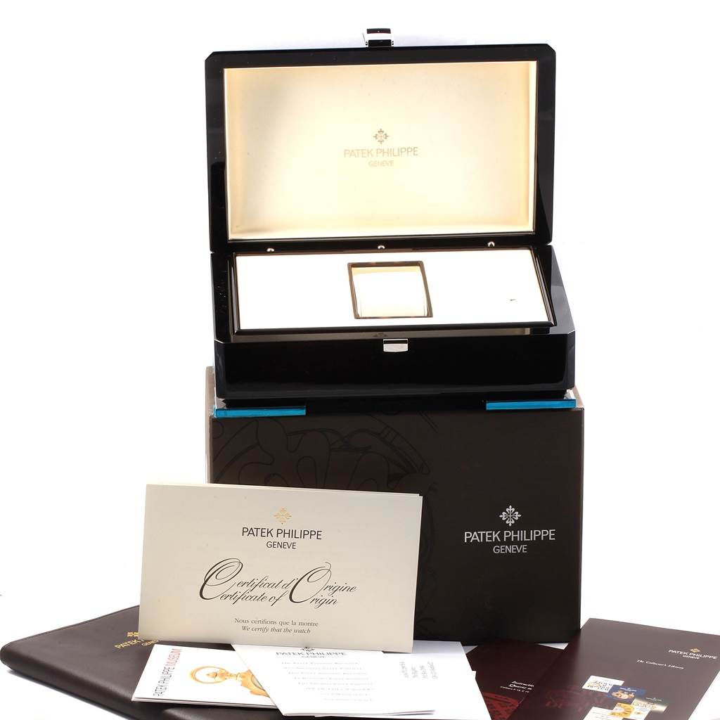 The image shows the Patek Philippe Twenty-4 4910/10A-010 Women's Stainless Steel Grey Dial 4910/10A-010 Women's Stainless Steel Grey Dial watch box, certificates, and associated manuals from a front angle.