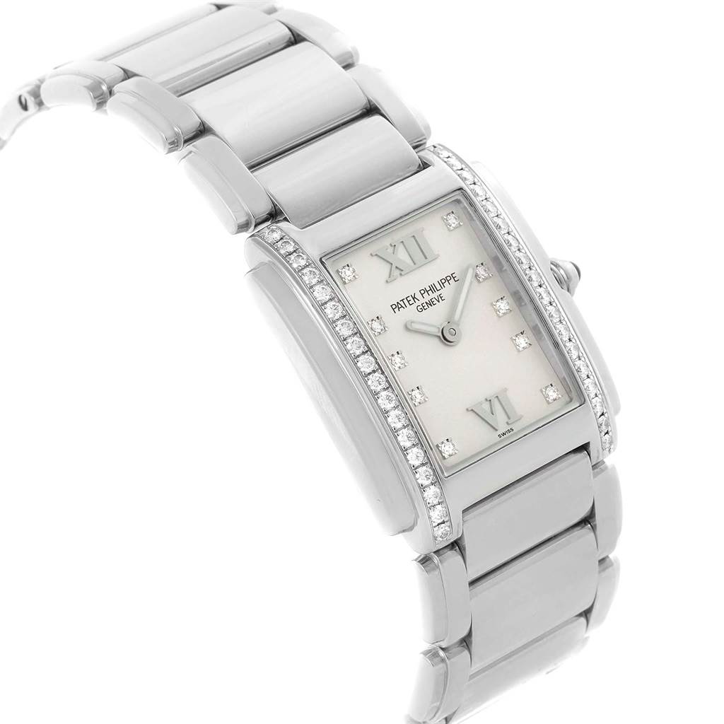 The image shows a side angle of the Patek Philippe Twenty-4 4910 Women's Stainless Steel Silver Dial 4910 Women's Stainless Steel Silver Dial watch, highlighting the bracelet, case, and diamond-accented bezel.