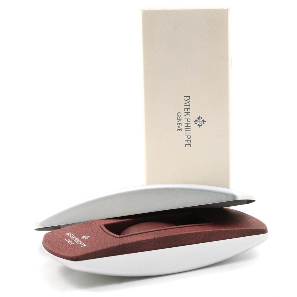 The image shows the packaging for the Patek Philippe Twenty-4 4910 Women's Stainless Steel Silver Dial 4910 Women's Stainless Steel Silver Dial watch, including a branded box and cushioned case.