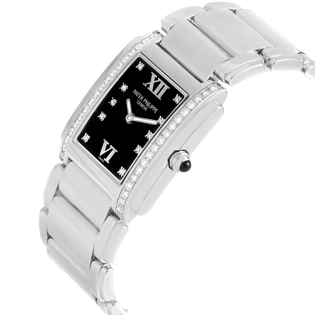 The Patek Philippe Twenty-4 4910 Women's Stainless Steel Black Dial 4910 Women's Stainless Steel Black Dial watch is shown from a 3/4 top angle, highlighting the face, bezel, and part of the bracelet.