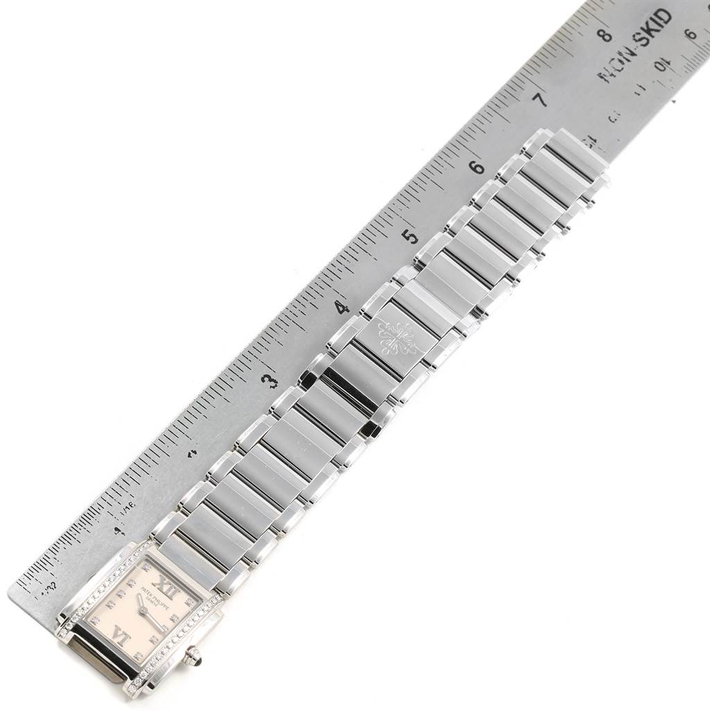 The image shows a full frontal view of a Patek Philippe Twenty-4 4910 Women's Stainless Steel Silver Dial 4910 Women's Stainless Steel Silver Dial watch, including the band and part of the ruler for scale.