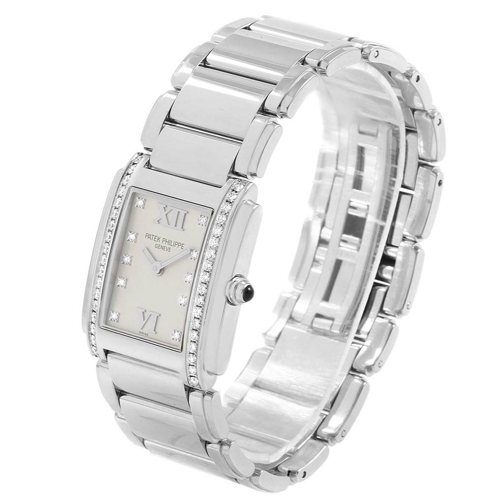 The image shows a Patek Philippe Twenty-4 4910 Women's Stainless Steel Silver Dial 4910 Women's Stainless Steel Silver Dial watch from an angled side view, highlighting its bracelet and diamond-studded face.