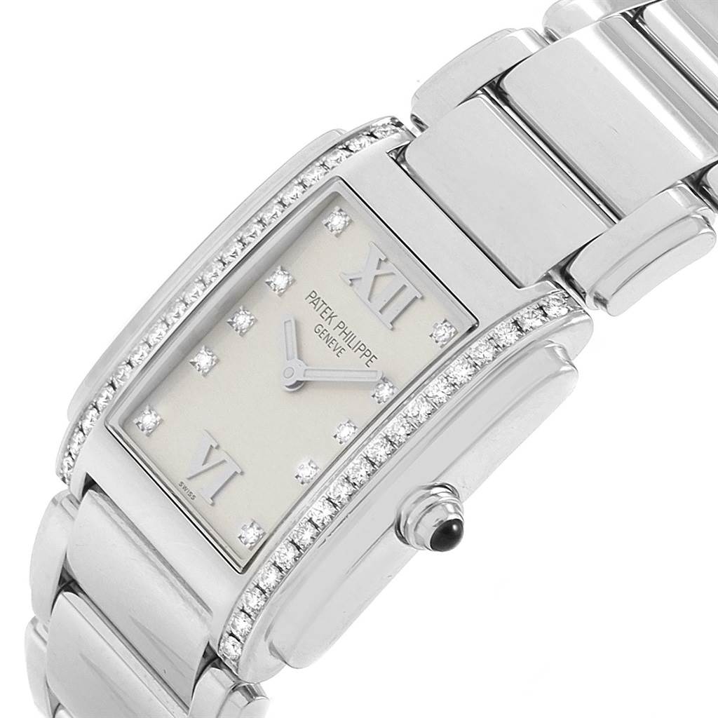The image shows a close-up of the face and band of a Patek Philippe Twenty-4 4910 Women's Stainless Steel Silver Dial 4910 Women's Stainless Steel Silver Dial model watch, highlighting the diamond-encrusted bezel and the rectangular dial.