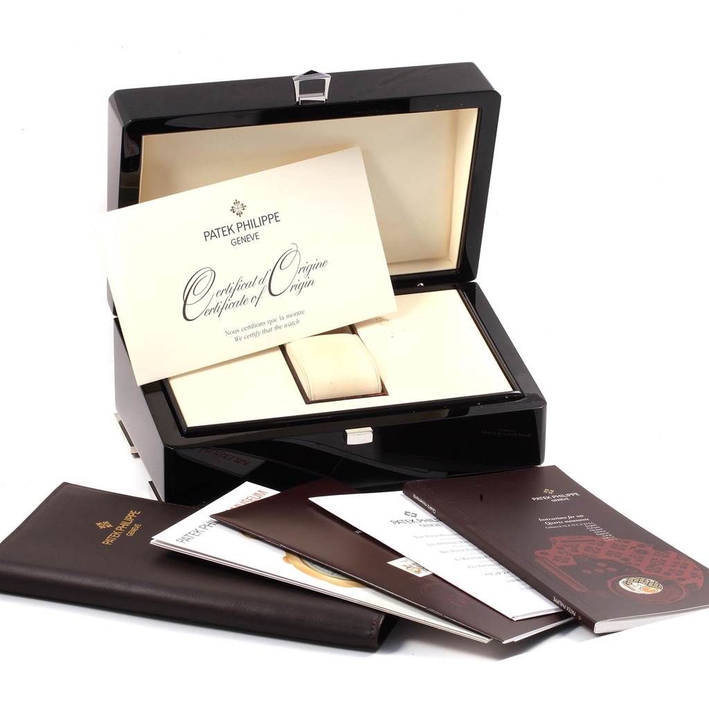 The image shows the Patek Philippe Twenty-4 4910 Women's Stainless Steel Silver Dial 4910 Women's Stainless Steel Silver Dial model's box, certificate of origin, and accompanying booklets from a frontal angle.