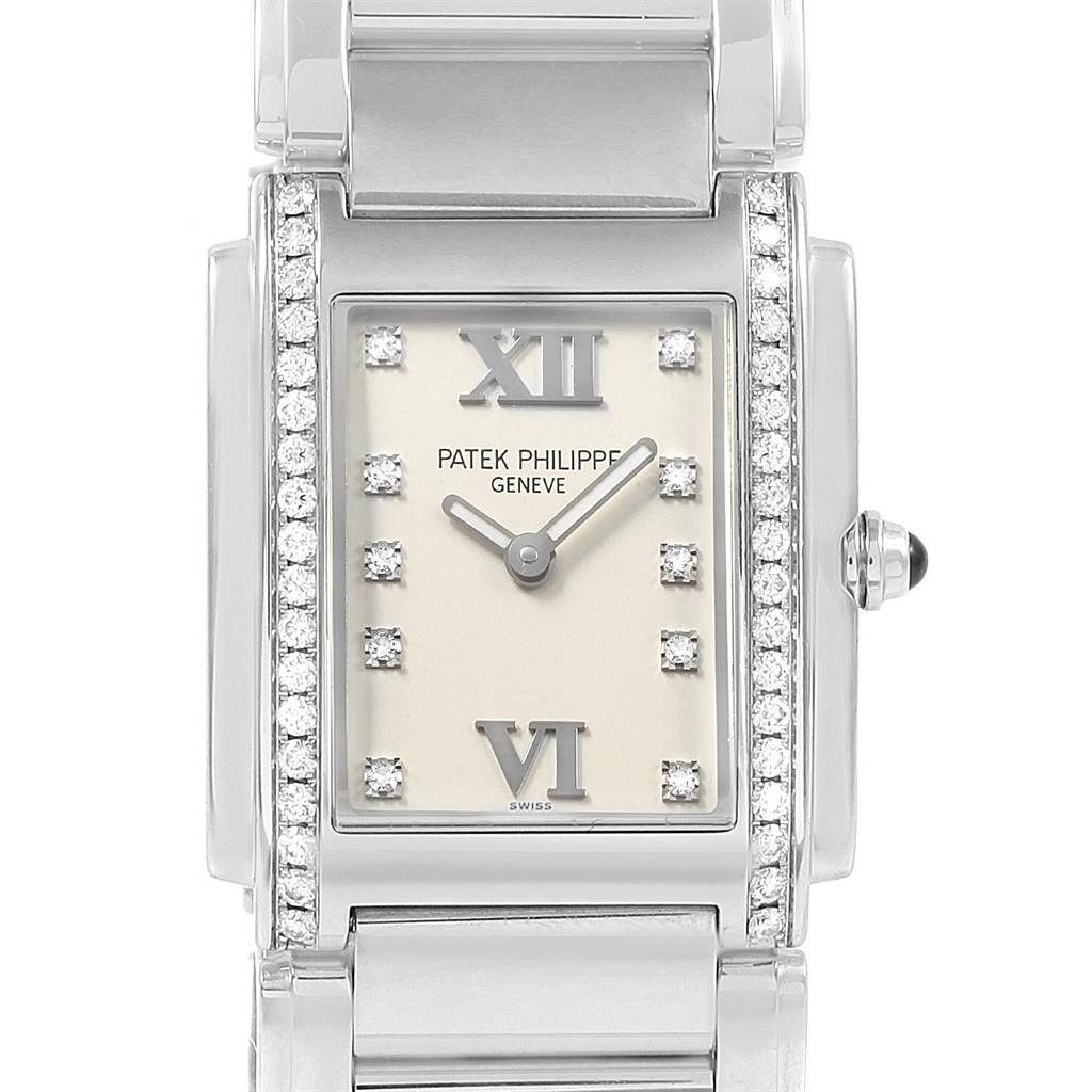 The Patek Philippe Twenty-4 4910 Women's Stainless Steel Silver Dial 4910 Women's Stainless Steel Silver Dial watch is shown from the front, highlighting its face, bezel, and part of its bracelet.