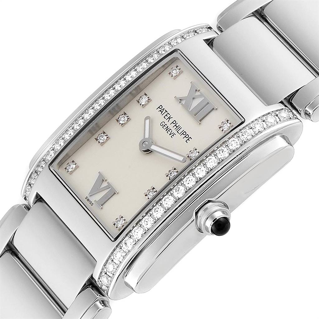 The image shows a close-up view of the dial, case, and bracelet of the Patek Philippe Twenty-4 4910/10A-010 Women's Stainless Steel Silver Dial 4910/10A-010 Women's Stainless Steel Silver Dial watch, highlighting its diamonds and crown.