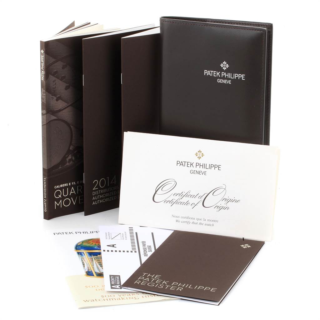 The image shows booklets, certificates, and a leather case, all related to the Patek Philippe Twenty-4 4910-10A-001 Women's Stainless Steel Black Dial 4910-10A-001 Women's Stainless Steel Black Dial model.