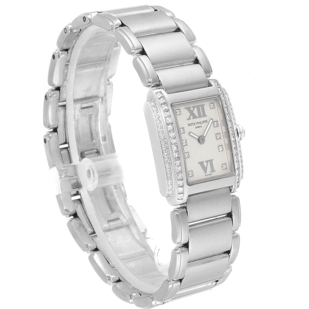 The image shows a side angle of a Patek Philippe Twenty-4 4908/200G-011 Women's White Gold Silver Dial 4908/200G-011 Women's White Gold Silver Dial watch, highlighting its bracelet and diamond-set rectangular case.