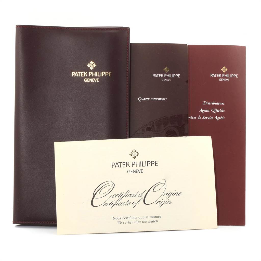 The image shows the documents and packaging for a Patek Philippe Twenty-4 4908/200G-011 Women's White Gold Silver Dial 4908/200G-011 Women's White Gold Silver Dial model, including a leather folder, manuals, and certificate of origin.