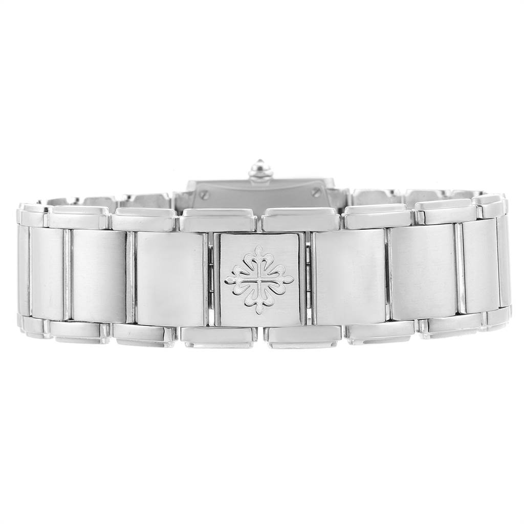 This image shows the bracelet of the Patek Philippe Twenty-4 4908/200G-011 Women's White Gold Silver Dial 4908/200G-011 Women's White Gold Silver Dial watch from a top-down angle, focusing on the central clasp with the brand emblem.
