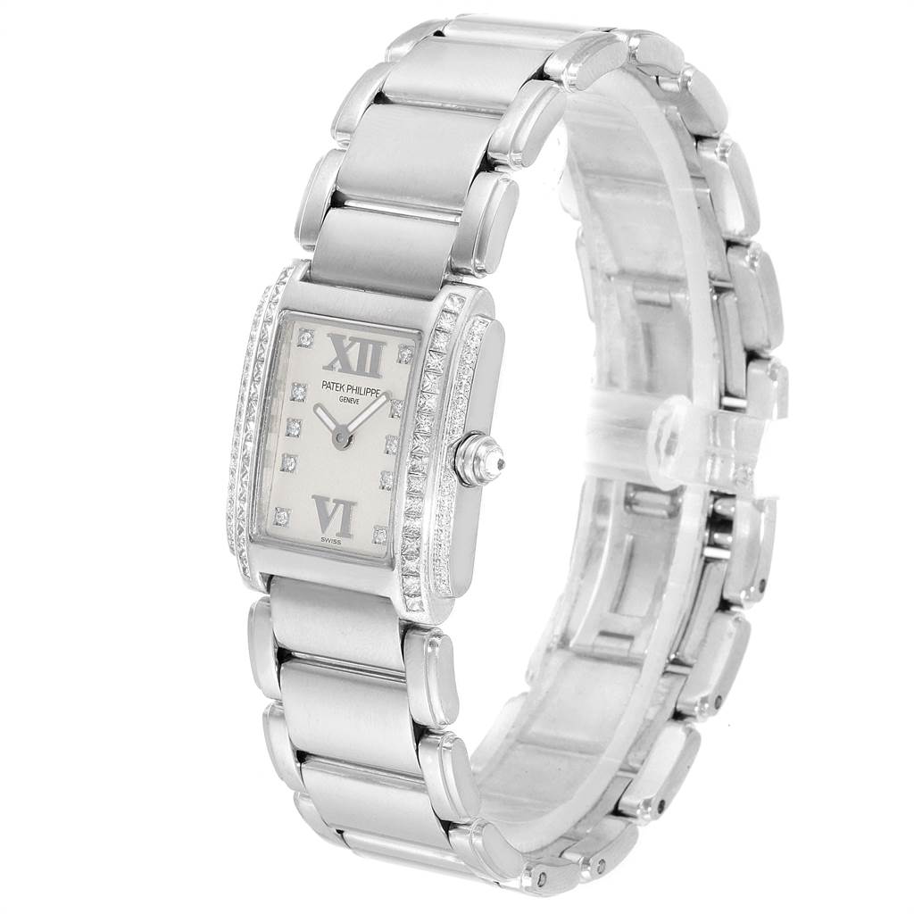 The image shows a frontal angle of a Patek Philippe Twenty-4 4908/200G-011 Women's White Gold Silver Dial 4908/200G-011 Women's White Gold Silver Dial watch, highlighting its dial, bracelet, and side diamonds.