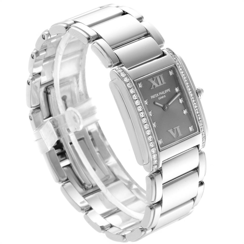 The image shows a Patek Philippe Twenty-4 4910/10A-010 Women's Stainless Steel Grey Dial 4910/10A-010 Women's Stainless Steel Grey Dial watch at a three-quarter angle, highlighting the dial, case, and bracelet.