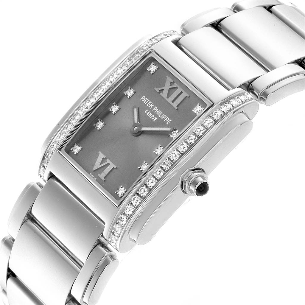 This image shows a Patek Philippe Twenty-4 4910/10A-010 Women's Stainless Steel Grey Dial 4910/10A-010 Women's Stainless Steel Grey Dial watch displaying its face, bracelet, crown, and diamond detailing from a side angle.