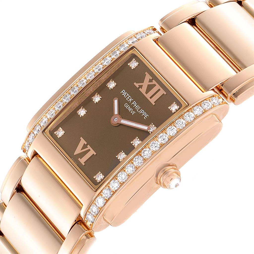 This is a close-up view of a Patek Philippe Twenty-4 4910/11R Women's Rose Gold Brown Dial 4910/11R Women's Rose Gold Brown Dial watch, displaying its face, diamond accents, and part of the band.