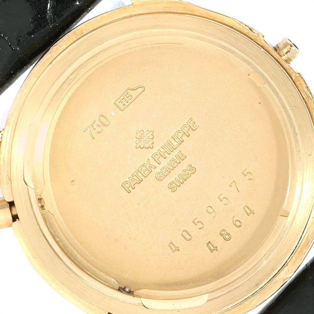 The image shows the back casing of a Patek Philippe Calatrava 4864J Women's Yellow Gold White Dial 4864J Women's Yellow Gold White Dial watch, displaying hallmarks and serial numbers.
