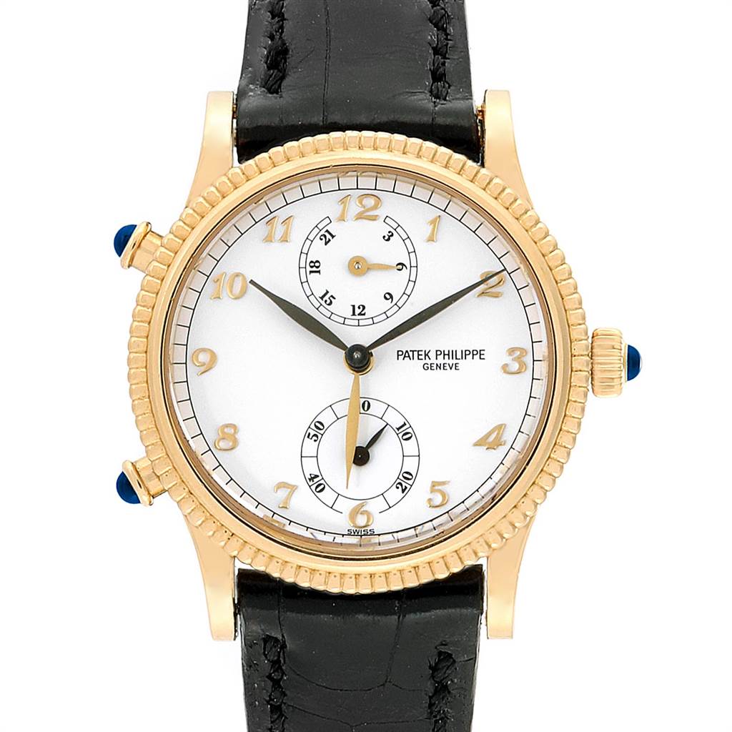The Patek Philippe Calatrava 4864J Women's Yellow Gold White Dial 4864J Women's Yellow Gold White Dial watch is shown from a front angle, displaying its face, hands, crown, subdials, and leather strap.