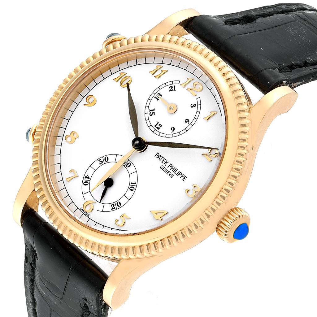 The Patek Philippe Calatrava 4864J Women's Yellow Gold White Dial 4864J Women's Yellow Gold White Dial watch is shown at an oblique angle, highlighting its face, crown, and strap.