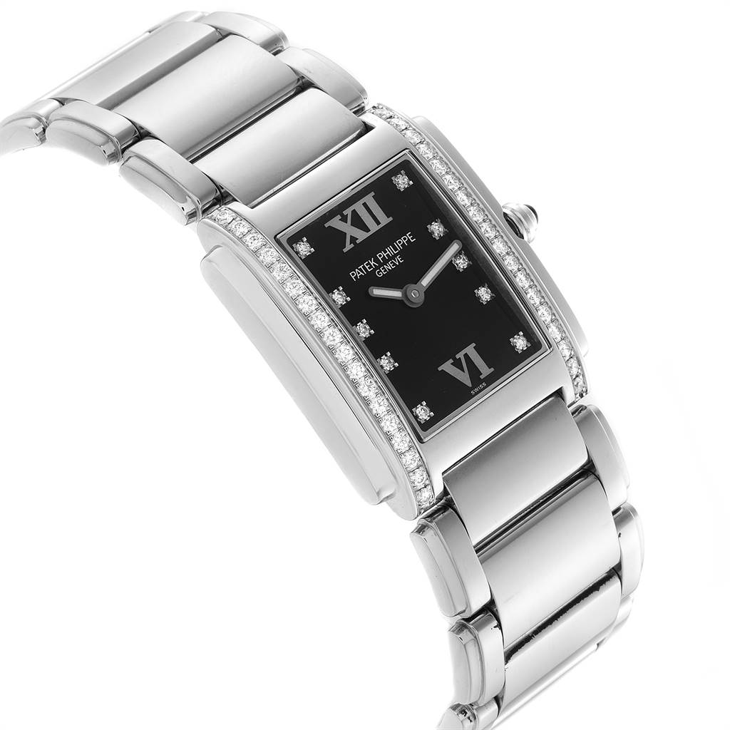 The image shows a side angle of a Patek Philippe Twenty-4 4910-10A-001 Women's Stainless Steel Black Dial 4910-10A-001 Women's Stainless Steel Black Dial watch highlighting its black dial, diamond accents, and stainless steel bracelet.