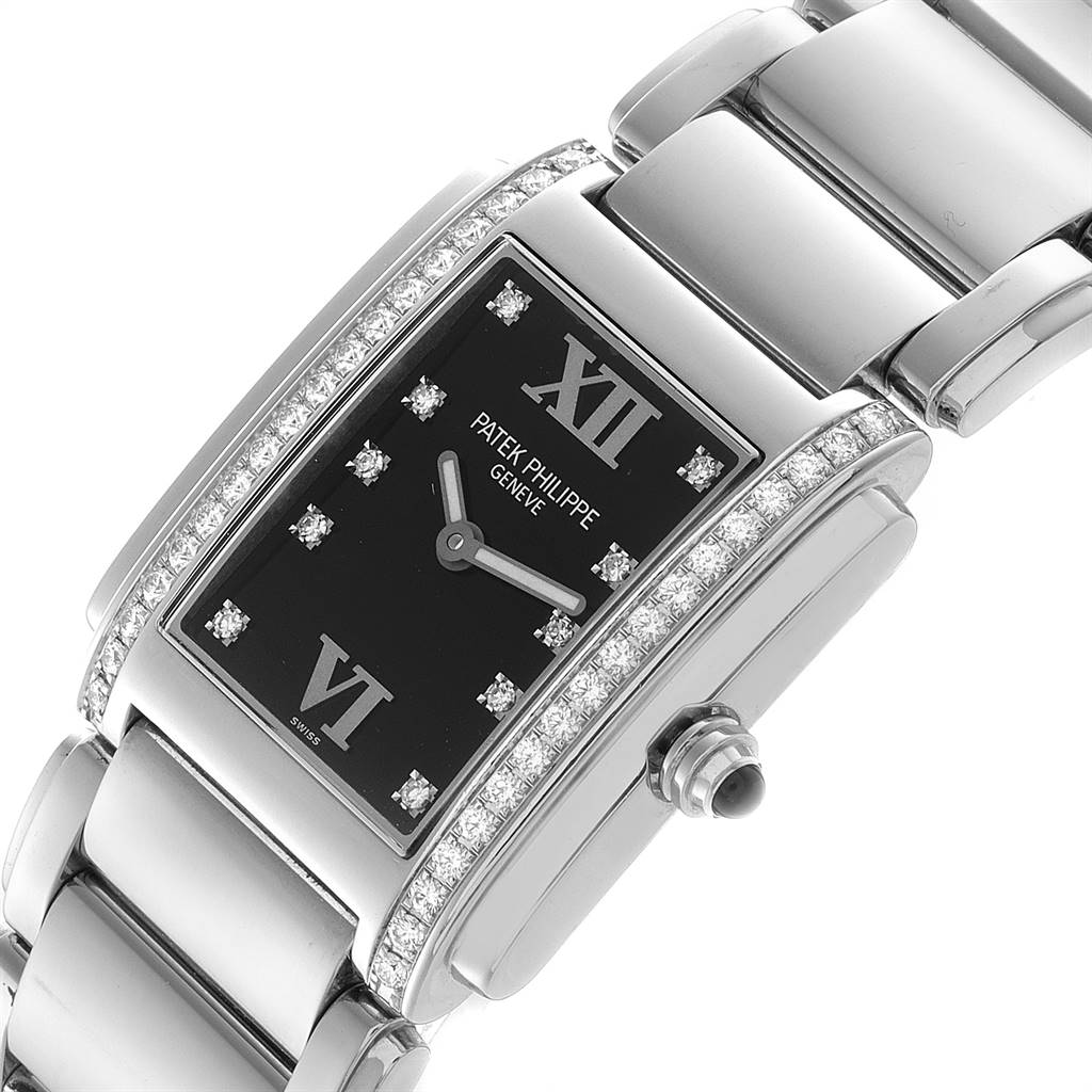 This image shows a Patek Philippe Twenty-4 4910-10A-001 Women's Stainless Steel Black Dial 4910-10A-001 Women's Stainless Steel Black Dial model watch at an angle, highlighting its face, bezel, dialect, and part of its bracelet.