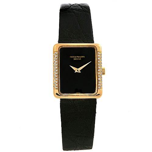 This image shows the front view of a Vintage Patek Philippe watch, featuring a rectangular gold case with diamond accents and a black leather strap.