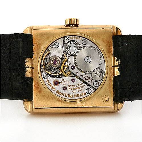 This is a rear view of a Vintage Patek Philippe watch showing the movement and internal mechanisms with an open case back.
