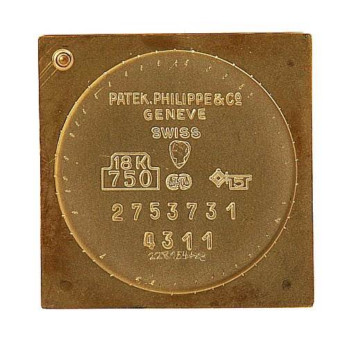 The image shows the back cover of a Vintage Patek Philippe watch, displaying engravings and hallmarks.