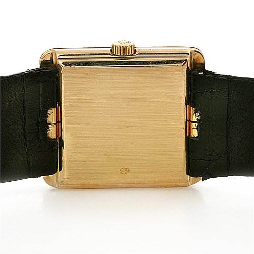 This image shows the back view of a Vintage Patek Philippe watch, focusing on the case and crown with its leather straps visible.