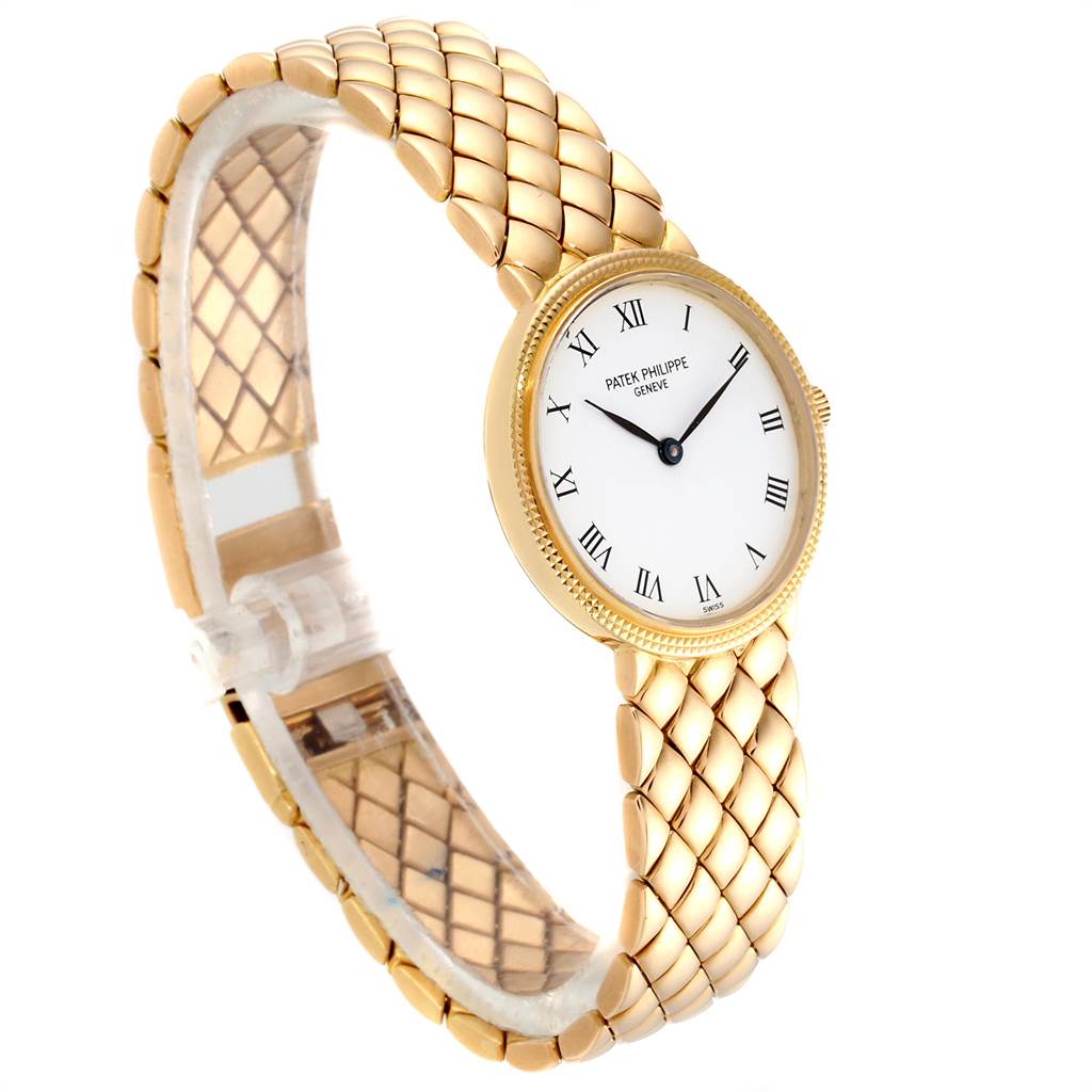 This image shows a side angle of the Patek Philippe Calatrava 4819 Women's Yellow Gold White Dial 4819 Women's Yellow Gold White Dial watch, highlighting its white dial, Roman numerals, and gold bracelet.
