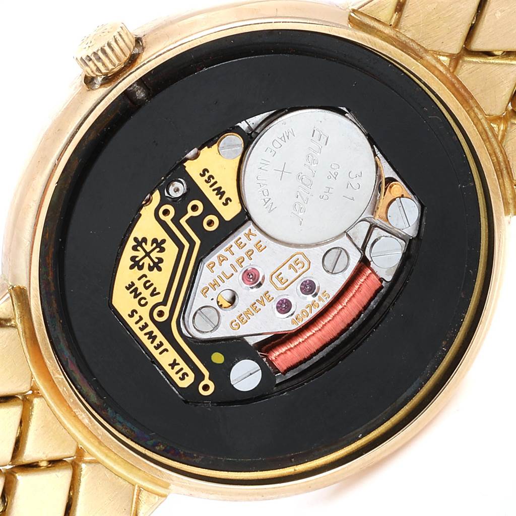 The image shows the back casing of a Patek Philippe Calatrava 4819 Women's Yellow Gold White Dial 4819 Women's Yellow Gold White Dial watch, revealing the watch's internal battery and movement components.